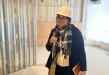 Peterborough Community Health Centre executive director Ashley Safar gives a thumbs up as she reviews the progress of construction of the centre's new longer-term location on two floors of Peterborough Square mall, where the centre is currently operating out of a temporary location. (Photo: Peterborough Community Health Centre)