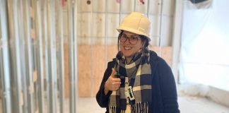 Peterborough Community Health Centre executive director Ashley Safar gives a thumbs up as she reviews the progress of construction of the centre's new longer-term location on two floors of Peterborough Square mall, where the centre is currently operating out of a temporary location. (Photo: Peterborough Community Health Centre)