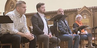 Four out of the five registered candidates for the Peterborough-Kawartha riding in the upcoming Ontario election participated in an all-candidates debate on homelessness and housing at All Saints' Anglican Church in Peterborough on February 12, 2025. Pictured from left to right are Andrew Roudly of the New Blue Party, Lucas Graham of the Green Party of Ontario, Adam Hopkins of the Ontario Liberal Party, and Jen Deck of the Ontario NDP, with an empty chair for incumbent Dave Smith of the PC Party of Ontario, who chose not to participate. (Photo: Paul Rellinger / kawarthaNOW)