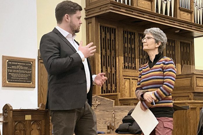 Green Party candidate Lucas Graham speaks with debate co-moderator Joelle Favreau at an all-candidates provincial election debate on homelessness and housing at All Saints' Anglican Church in Peterborough on February 12, 2025. Peterborough-Kawartha MPP Dave Smith was the only candidate who did not participate in the debate. (Photo: Paul Rellinger / kawarthaNOW)