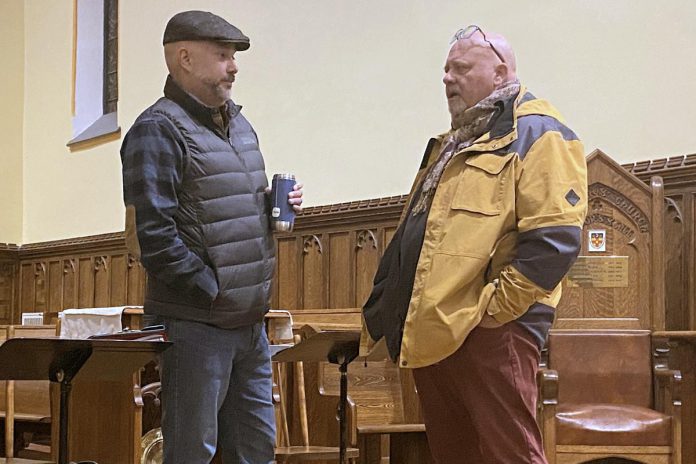 Liberal candidate Adam Hopkins speaks with United Way of Peterborough and District CEO Jim Russell at an all-candidates provincial election debate on homelessness and housing at All Saints' Anglican Church in Peterborough on February 12, 2025. The debate was presented by the United Way along with One City Peterborough, Trent University's Research for Social Change Lab, and All Saints' Anglican Church. Peterborough-Kawartha MPP Dave Smith was the only candidate who did not participate in the debate. (Photo: Paul Rellinger / kawarthaNOW)