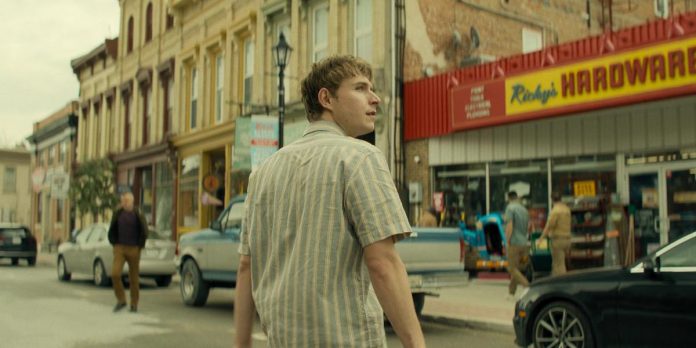 Richard Beck (Johnny Berchtold) walks across King Street in downtown Millbrook in a scene from the third episode of the third season of the action-thriller series "Reacher" streaming now on Amazon Prime Video. Pictured in the background is Millbrook Home Hardware standing in for Ricky's Hardware Store. (kawarthaNOW screenshot)