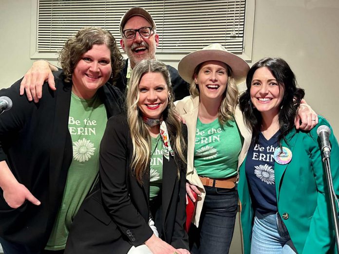 Musicians Kate Brioux, Paul Crough, Kate Suhr, Melissa Payne, and emcee Megan Murphy sport matching shirts reading "Be the Erin," as in "Be the Erin you want to see in the world," at a kitchen party fundraiser in honour of the late Erin Sullivan in March 2024. The second annual event, from which all proceeds go towards the mortgage of a home in Sullivan's name that houses people coming out of homelessness, will be held on March 14, 2025, at the Ennismore Community Centre. (Photo courtesy of Jessica Carroll)