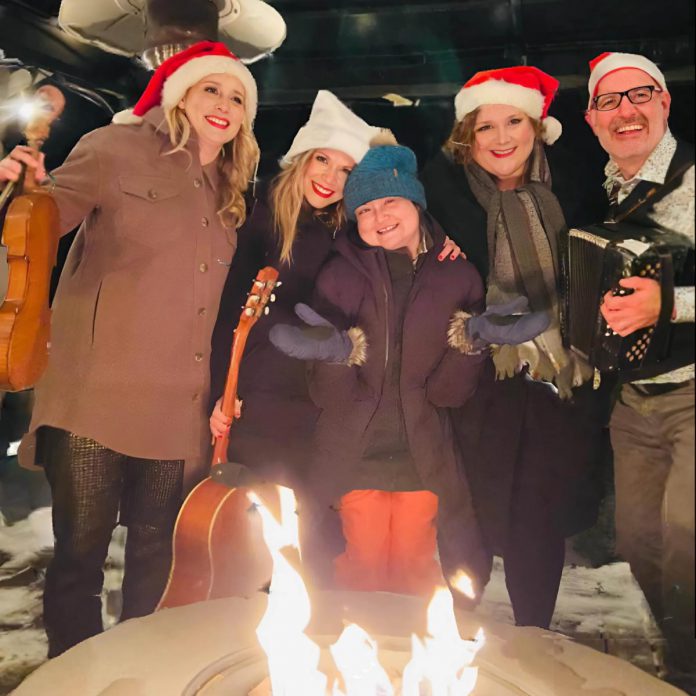 Erin Sullivan (middle) with (from left to right) Melissa Payne, Kate Suhr, Kate Brioux, and Paul Crough. The four musicians will be coming together for a kitchen party in honour of Sullivan on March 14, 2025, just the day after what would have been her 46th birthday. Hosted by Megan Murphy, the second annual event will include live music, stories, a silent auction, and a cash bar. All proceeds will be donated to the purchase of a One City Peterborough house in Sullivan's name that provides permanent housing to individuals coming out of homelessness. (Photo: Melissa Payne / Facebook)