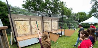 Attendees at the 2024 Backyard Summer Social hosted by Five Counties Children's Centre participate in axe throwing, one of the fun activities returning to the 2025 event on Saturday, June 21. The adults-only event is the signature fundraiser for Five Counties, with proceeds supporting high-demand services like speech therapy and occupational therapy in an effort to reduce long waiting times for kids to receive these critical services through the regional children's centre, which is celebrating its 50th anniversary. (Photo: Five Counties Children's Centre)