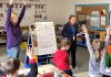 Five Counties clinicians Katy Morton (left) and Emily Vann get first and second graders at St. Joseph's Catholic Elementary School in Douro to stretch and show how "tallies" (letters like t, f, and b) differ from others in the alphabet. The exercise aims to reinforce proper printing techniques for the students. (Photo courtesy of Five Counties)