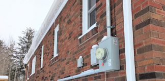 Madeleine Pengelley and David Pritchard's home in Peterborough's East City is fully powered by electricity and no longer has a connection to a gas line. The transition from gas has taken all fossil fuel combustion, and therefore all risk of carbon monoxide, out of their home. This photo shows their electricity meter and heat pump operating on a cold February morning. (Photo: Clara Blakelock / GreenUP)