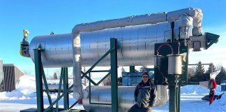 Norm Lamothe of Woodleigh Farms in Cavan stands in front of his new pyrolysis unit. This machinery is part of a system that will ultimately produce biochar, a carbon-sequestering beneficial soil amendment, from waste wood. (Photo courtesy of Lamothe family)