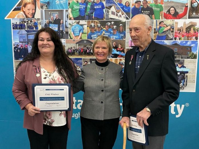 Habitat for Humanity Peterborough & Kawartha Region (Habitat PKR) volunteers Cindy Windover (left) and Harry Pearson (right), pictured with Selwyn Township Mayor Sherry Senis, were presented with the King Charles III's Coronation Medal on March 6, 2025 during a celebration at the Lakefield ReStore in recognition for their work with the organization. (Photo: Habitat PKR)