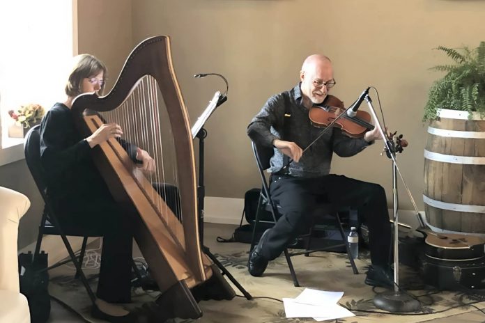 Harpist Tanah Haney and fiddler John Hoffman will perform as the Celtic duo Banish Misfortune at a family-friendly St. Patrick's Day Kitchen Party at Camp Kawartha Environment Centre on March 15, 2025. The vocal trio Hardwood Cat and Irish traditional quartet The Skelligs will also perform. (Photo courtesy of John Hoffman)