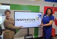 Christine Crandell and Nicole Stephenson, vice chair and chair of the Innovation Cluster's board of directors, show off the non-profit economic development organization's new logo at a launch event on March 20, 2025 at the Innovation Cluster's headquarters on the first floor of the Venture North building in downtown Peterborough. (Photo: Jeannine Taylor / kawarthaNOW)