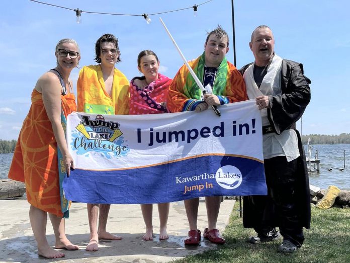 Kawartha Lakes real estate sales representives Dean Michel (right) and Jennifer Bacon (left) and their family after plunging into Balsam Lake for the Jump in the Lake Challenge on May 4, 2024. The 6th annual challenge, which encourages Coboconk-area residents to take to take a cold plunge into their local lake for a good cause, is being held on May 3, 2025 with the goal of raising $20,000 towards the Coboconk & Area Food Bank. (Photo courtesy of Dean Michel)