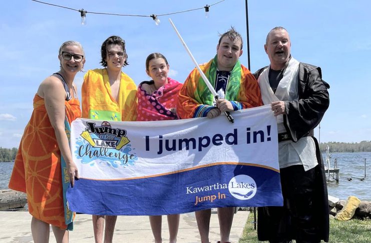 Kawartha Lakes real estate sales representives Dean Michel (right) and Jennifer Bacon (left) and their family after plunging into Balsam Lake for the Jump in the Lake Challenge on May 4, 2024. The 6th annual challenge, which encourages Coboconk-area residents to take to take a cold plunge into their local lake for a good cause, is being held on May 3, 2025 with the goal of raising $20,000 towards the Coboconk & Area Food Bank. (Photo courtesy of Dean Michel)
