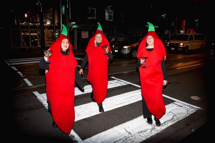 Glenna Walters, Julia Ettlinger, and Emily Callahan decked out as The Red Hot Sili Peppers with cocktails in hand. (Photo courtesy of The Red Hot Sili Peppers)