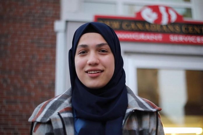 Fatma Al Ahmed, a high-school student from Syria, is one of six newcomers in Peterborough featured in the "Our Neighbourhood" video series produced in 2024 by the New Canadians Centre (NCC). In each of three free "Stories from Your Neighbourhood: Meet Your Neighbours" sessions on March 26, April 23, and May 21 at the Peterborough Public Library, the NCC will be facilitating public discussions of two newcomer stories featured in the videos along with related topics. (kawarthaNOW screenshot of NCC video)