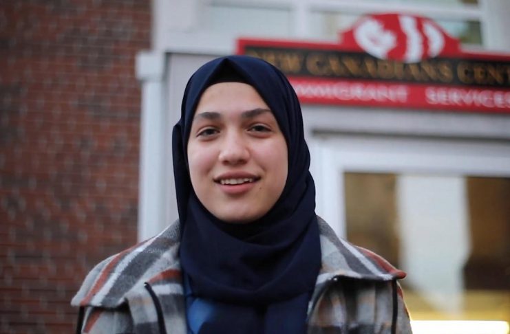 Fatma Al Ahmed, a high-school student from Syria, is one of six newcomers in Peterborough featured in the "Our Neighbourhood" video series produced in 2024 by the New Canadians Centre (NCC). In each of three free "Stories from Your Neighbourhood: Meet Your Neighbours" sessions on March 26, April 23, and May 21 at the Peterborough Public Library, the NCC will be facilitating public discussions of two newcomer stories featured in the videos along with related topics. (kawarthaNOW screenshot of NCC video)