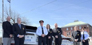 Chief Stuart Betts (third from left) marked the beginning of the celebrations of the Peterborough Police Service's 175th anniversary on March 18, 2025 by placing the police service's official 175th anniversary on marked patrol vehicles. Also pictured from left to right are police services board vice-chair Drew Merrett, Peterborough mayor and board member Jeff Leal, board chair Mary ten Doeschate, city councillor and board member Gary Baldwin, board member Steve Girardi, and deputy chief Jamie Hartnett. (Photo courtesy of Peterborough Police Service)