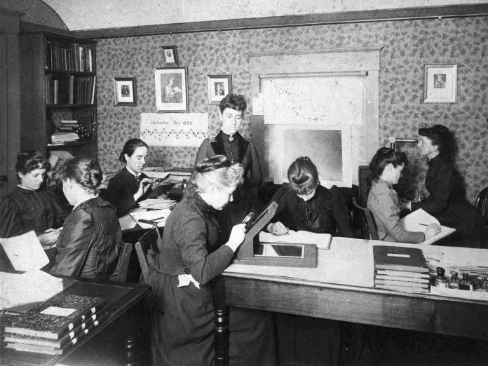 Circa 1890, Henrietta Swan Leavitt (third from left) works among "The Harvard Computers" who assisted astronomer Edward Charles Pickering at the Harvard College Observatory. The assistants also included Annie Jump Cannon, Williamina Fleming, and Antonia Maury. Reflecting the sexism of the time, the group was also nicknamed "Pickering's Harem." (Photo courtesy of Harvard College Observatory)