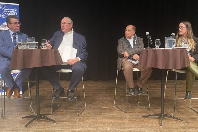 CIBC Wood Gundy advisor and portfolio manager Andrew Pyle, Armstrong Trade and Logistics Advisory Services president Bob Armstrong, Trent University economics professor Dr. Saud Choudry, and Peterboro Matboards CFO and Kawartha Manufacturers Association secretary Sherry Hill on stage at the Market Hall in downtown Peterborough on March 4, 2025 for a panel discussion on trade and U.S. tariffs co-hosted by Community Futures Peterborough, the Peterborough and Kawarthas Chamber of Commerce, and the Peterborough Downtown Business Improvement Association. (Photo: Paul Rellinger / kawarthaNOW)