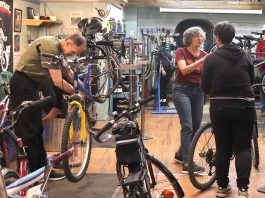 Bike mechanic and outreach manager Jean Greig conducts a workshop for Shifting Gears participants about the A, B, and Cs of bike maintenance at B!KE: The Peterborough Community Bike Shop in downtown Peterborough. The annual Shifting Gears May Challenge administered by GreenUP invites Peterborough residents to shift the way they move for the month of May, whether by walking, cycling, taking public transit, or carpooling. (Photo: Lili Paradi)