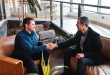 Andrew Nokes, founder of Creativity by Code and ReziLink, shakes hands with Eduard Yonathan, founder of SanoStrategy. Both tech entrepreneurs are clients of the Innovation Cluster, which serves early-stage small and medium-sized businesses in the cleantech, agritech, health and medical tech, nuclear, and digital tech sectors. (Photo: Bryan Reid for Innovation Cluster