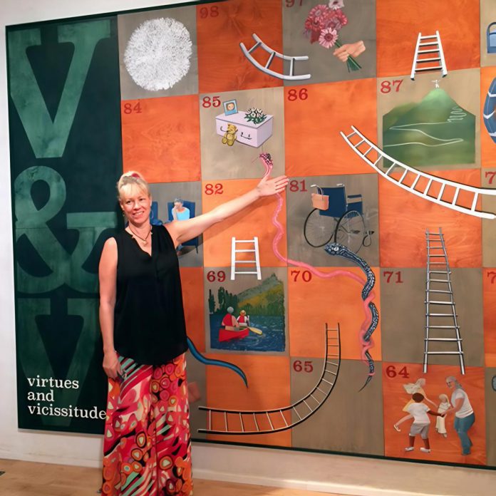 Visual artist Ramune Luminaire standing beside her "Virtues & Vicissitudes" art installation for the "Coming of Age" exhibit in Bowmanville in 2017. Done in collaboration with other local female artists, the exhibit reflects the social and personal perceptions of aging, which Luminaire continues to explore in her debut novel "Coming of Age ... Again." (Photo courtesy of Ramune Luminaire)