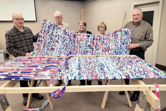 Volunteers of Calvary Pentecostal Church in Peterborough meet for two hours every week to transform plastic milk bags into sleeping mats for the local unhoused population, using two looms built by church group organizer Tim Young. Now, through Clean Up Peterborough, businesses and organizations can sponsor the build of a loom to provide more opportunity for volunteer groups to create sleeping mats. (Photo: Street Level Advocacy / Facebook) Volunteers of Calvary Pentecostal Church in Peterborough meet for two hours every week to transform plastic milk bags into sleeping mats for the local unhoused population, using two looms built by church group organizer Tim Young. Now, through Clean Up Peterborough, businesses and organizations can sponsor the build of a loom to provide more opportunity for volunteer groups to create sleeping mats. (Photo: Street Level Advocacy / Facebook)