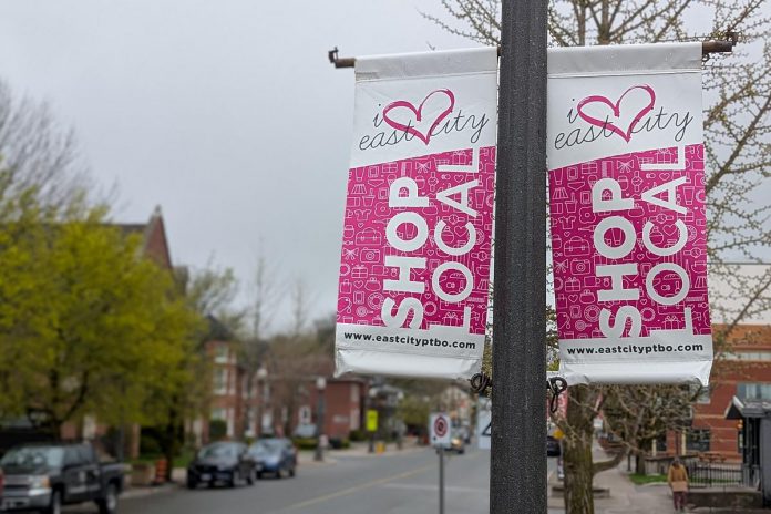 Light post banners on Hunter Street East in Peterborough's East City installed by the volunteer-led East City Village Business Improvement Area, which is merging with the Peterborough Downtown Business Improvement Area as part of a one-year pilot agreement. (Photo: Bruce Head / kawarthaNOW) Light post banners on Hunter Street East in Peterborough's East City installed by the volunteer-led East City Village Business Improvement Area, which is merging with the Peterborough Downtown Business Improvement Area as part of a one-year pilot agreement. (Photo: Bruce Head / kawarthaNOW)