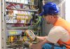 An electrician testing circuits. (Stock photo)