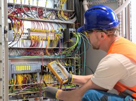 An electrician testing circuits. (Stock photo)