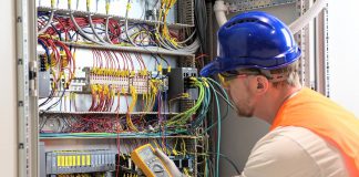 An electrician testing circuits. (Stock photo)