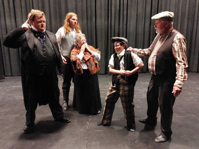 In a scene from "Crossing Over", John Keleher (Hugh Foley, right) brings petty thief Tim Ryan (Kaza Hesselink, second from right) to the John Barry surgeon-superintendent William Burnie (Ashley Parker, left) for ship board justice. Mr. and Mrs. Hagarty (Lucas Pronk and Cathy Brand, centre) are worried, having their own secrets to keep. (Photo courtesy of Trent Valley Archives Theatre)