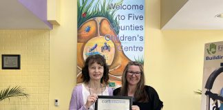 Five Counties Children's Centre clinical services director Darlene Callan and executive assistant Brandi Williamson-Meletiou display the three-year accreditation plaque from the Commission on Accreditation of Rehabilitation Facilities (CARF). In 1985, Five Counties was the very first children's treatment centre in Ontario to be accredited by the independent non-profit accreditor of health and human resources, and it has maintained its accreditation ever since. (Photo: Five Counties Children's Centre)