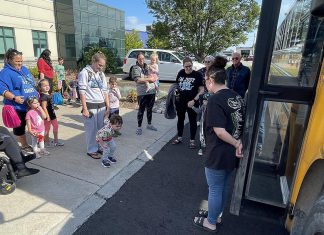 Families attending Five Counties Children's Centre's 'Ready for School' event in Cobourg in August 2024 prepare to board a school bus to see what the ride entails. Offering supports for children who may face greater challenges due to physical, developmental, or communication needs, the events are returning in Peterborough, Cobourg, and Lindsay in spring 2025 to provide families with even more time to prepare. (Photo: Five Counties)