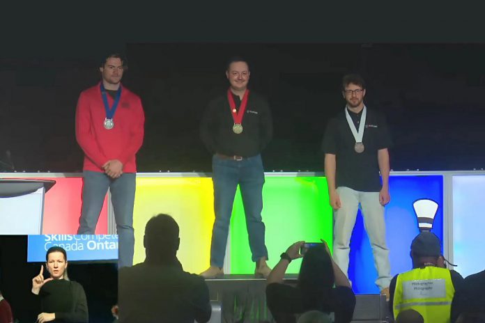 Fleming College students Dylan Waddell (middle) and Gavin O'Rourke (right) with their gold and bronze medals in carpentry during the awards ceremony for the 2025 Skills Ontario Competition on May 7. In total, Fleming College students earned five gold and two bronze medals at the competition, during which secondary and post-secondary students competed in a range of hands-on challenges. (kawarthaNOW screenshot) Fleming College students Dylan Waddell (middle) and Gavin O'Rourke (right) with their gold and bronze medals in carpentry during the awards ceremony for the 2025 Skills Ontario Competition on May 7. In total, Fleming College students earned five gold and two bronze medals at the competition, during which secondary and post-secondary students competed in a range of hands-on challenges. (kawarthaNOW screenshot)
