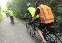 Between the lone line of tandem bicycles and the bright colours, a TandemEyes group ride is hard to miss on a summer evening. Here, the group passes through Jackson Park in Peterborough on the way to the Orange Corners trestle bridge. (Photo courtesy of TandemEyes)