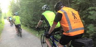 Between the lone line of tandem bicycles and the bright colours, a TandemEyes group ride is hard to miss on a summer evening. Here, the group passes through Jackson Park in Peterborough on the way to the Orange Corners trestle bridge. (Photo courtesy of TandemEyes)