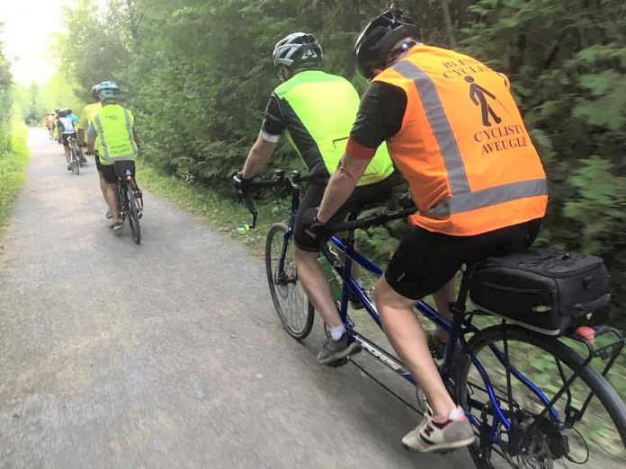 Between the lone line of tandem bicycles and the bright colours, a TandemEyes group ride is hard to miss on a summer evening. Here, the group passes through Jackson Park in Peterborough on the way to the Orange Corners trestle bridge. (Photo courtesy of TandemEyes) Between the lone line of tandem bicycles and the bright colours, a TandemEyes group ride is hard to miss on a summer evening. Here, the group passes through Jackson Park in Peterborough on the way to the Orange Corners trestle bridge. (Photo courtesy of TandemEyes)