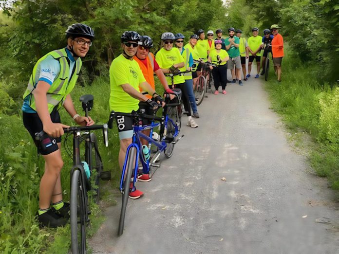 Favourite routes for TandemEyes rides include sections of the Trans Canada Trail. A large group of captains, stokers, and sweeps take a rest break on a summer evening ride. (Photo: Darcy Wefers)