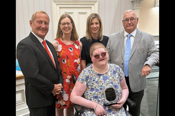 The late Kathryn Peeters pictured in June 2023 holding her Barbara McArthur Award of Distinction from the City of Kawartha Lakes, along with city councillor Charlie McDonald, kawartha Lakes Accessibility Advisory Committee chair Diane Engelstad, Kawartha Lakes Inclusion, Equity, Diversity and Accessibility (IDEA) Partner Christine Briggs, and Mayor Doug Elmslie. A new Youth Accessibility Award, to be presented at the Accessibility Awareness Recognition Awards in 2026, will be named after Peeters. (Photo: City of Kawartha Lakes) The late Kathryn Peeters pictured in June 2023 holding her Barbara McArthur Award of Distinction from the City of Kawartha Lakes, along with city councillor Charlie McDonald, kawartha Lakes Accessibility Advisory Committee chair Diane Engelstad, Kawartha Lakes Inclusion, Equity, Diversity and Accessibility (IDEA) Partner Christine Briggs, and Mayor Doug Elmslie. A new Youth Accessibility Award, to be presented at the Accessibility Awareness Recognition Awards in 2026, will be named after Peeters. (Photo: City of Kawartha Lakes)