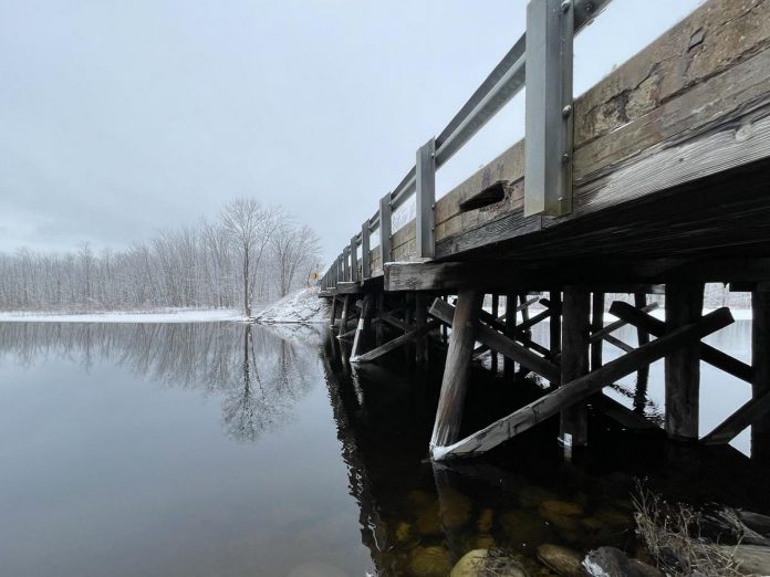Located on Kirkfield Road across the narrows of Lake Dalrymple in Kawartha Lakes, Lake Dalrymple Bridge was built out of timber with a concrete deck circa 1970 and needs to be replaced due to continued deterioration of wood, concrete, and asphalt as well as erosion. (Photo: Tatham Engineering) Located on Kirkfield Road across the narrows of Lake Dalrymple in Kawartha Lakes, Lake Dalrymple Bridge was built out of timber with a concrete deck circa 1970 and needs to be replaced due to continued deterioration of wood, concrete, and asphalt as well as erosion. (Photo: Tatham Engineering)
