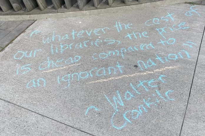 A sidewalk message about the importance of public libraries during a May 15, 2025 rally outside the Peterborough Public Library to protest the facility's recently publicized restructuring and staffing cuts. (Photo courtesy of Our Future Peterborough)