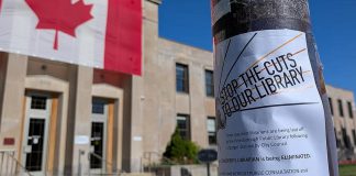 One of Our Future Peterborough's flyers taped to a light pole in front of Peterborough City Hall. Fighting against the restructuring and job elimination at the Peterborough Public Library is the "spark" that encouraged three Peterborough parents to form the grassroots organization committed to protecting the city's public services for children and families. (Photo courtesy of Our Future Peterborough)
