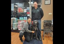 Bancroft and Bobcaygeon Pet Valu owners Nicole and Sean Courtney with their late dog Kona in the Bancroft store. Staffed with knowledgeable employees, both locally owned stores are stocked with Canadian products, offer in-store vendor demonstrations of vet-approved products, provide nail trim clinics, host events in partnership with local community organizations, and more. (Photo courtesy of Nicole and Sean Courtney)