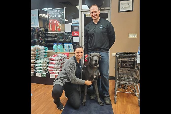 Bancroft and Bobcaygeon Pet Valu owners Nicole and Sean Courtney with their late dog Kona in the Bancroft store. Staffed with knowledgeable employees, both locally owned stores are stocked with Canadian products, offer in-store vendor demonstrations of vet-approved products, provide nail trim clinics, host events in partnership with local community organizations, and more. (Photo courtesy of Nicole and Sean Courtney) Bancroft and Bobcaygeon Pet Valu owners Nicole and Sean Courtney with their late dog Kona in the Bancroft store. Staffed with knowledgeable employees, both locally owned stores are stocked with Canadian products, offer in-store vendor demonstrations of vet-approved products, provide nail trim clinics, host events in partnership with local community organizations, and more. (Photo courtesy of Nicole and Sean Courtney)