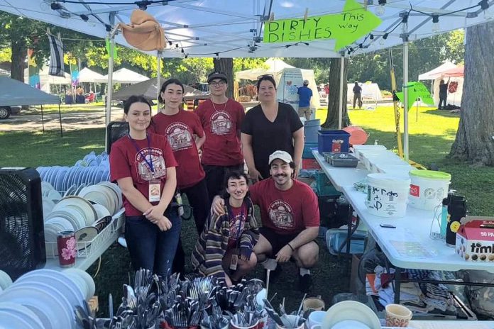 Through the help of more than 200 volunteers and board and committee members, the Peterborough Folk Fest continues to adapt to maintain its sustainability for years to come. With a focus on eco-friendly initiatives, the festival enlists volunteers to wash reusable dishes for the weekend's food vendors. (Photo courtesy of Peterborough Folk Festival)