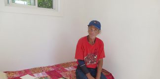 Terry, a Peterborough resident who supports himself by delivering papers and recycling bottles and cans, tries out the prototype sleeping cabin built by Peterborough Action for Tiny Homes (PATH). After leasing a site at 385 Lansdowne Street East from Habitat for Humanity Peterborough and Kawartha Region, PATH applied to the City of Peterborough for a temporary use zoning by-law amendment to build 24 one-room sleeping cabins with wrap-around services to help address the city's homelessness crisis. Although city staff recommended approval of the application, Peterborough city council voted against it, prompting PATH to appeal the decision to the Ontario Land Tribunal. (Photo: Peterborough Action for Tiny Homes)