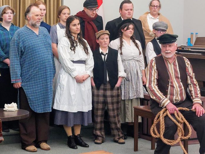 Trent Valley Archives Theatre performed a preview of its Peter Robinson settler play "Crossing Over" at Princess Gardens Retirement Residence on May 21, 2025. Front row: Hugh Foley as John Keleher; middle row: Nathan Govier as Patrick, Robyn Hawthorne as Elizabeth, Kaza Hesselink as Tim, Kalla Tahon as Elinor, Sianna Gaulton as Johanna; back row: Zoe Shufelt as Francis, Adrianna Malloy as Eliza, Lily Faulkner as Honora, Justin O'Brien as Captain Roche, Ashley Parker as William Burnie, and Elaine Day as Mrs. Owen. (Photo: Ed Schroeter)