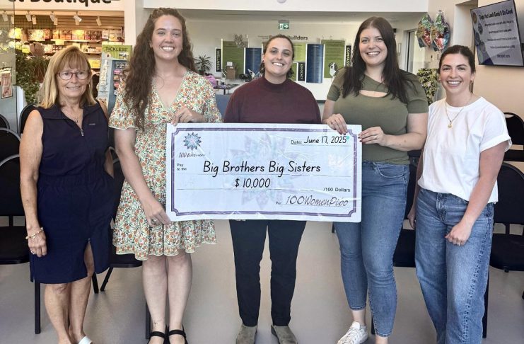 Big Brothers Big Sisters of Peterborough executive director Zoe King (middle) accepts a $10,000 donation from 100 Women Peterborough at the collective philanthropy group's second meeting of 2025 at the Peterborough Humane Society on Tuesday, June 17. (Photo courtesy of 100 Women Peterborough)