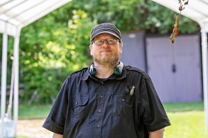 Justin Hiscox, musical director and composer for "The Housekeeper" by Robert Winslow and Ian McLachlan, at a media day hosted by 4th Line Theatre on June 18, 2025 at the Winslow Farm in Millbrook. Along with director Robert Winslow, other members of the creative team include assistant director Hilary Wear, costume designer Bonnie Garland, set designer Esther Vincent, sound designer Steáfán Hannigan, and fight director Edward Belanger, with Gailey Monner and Mikayla Stoodley on the stage management team. (Photo: Jordan Lyall Photography for kawarthaNOW)